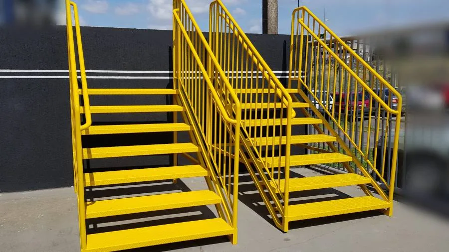 Conjunto de escadas metálicas amarelas de uso industrial